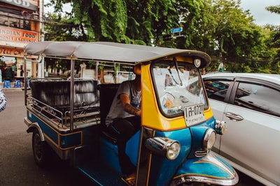 Blue and yellow electric rickshaws
